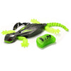 Black wall-climbing RC gecko toy with bright green glowing appendages and a controller.