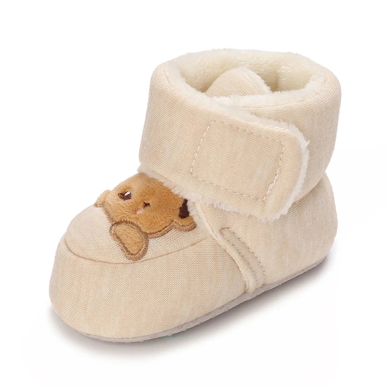 A pair of beige baby winter cartoon boots with a soft faux fur lining and non-slip sole.