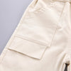 A close-up of a beige kids' summer outfit set featuring a top and shorts.
