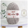 A ball of gray chenille yarn with a white label featuring Chinese characters for knitting and crochet