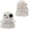 A handmade knitted white bat doll with a black face and a card attached.