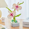 A set of rose flower building blocks in pink and green colors displayed on a wooden table.