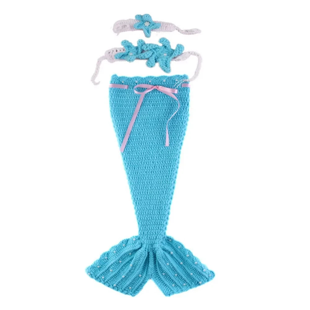Newborn mermaid photoshoot set featuring a turquoise knit tail skirt and a matching pearl headband