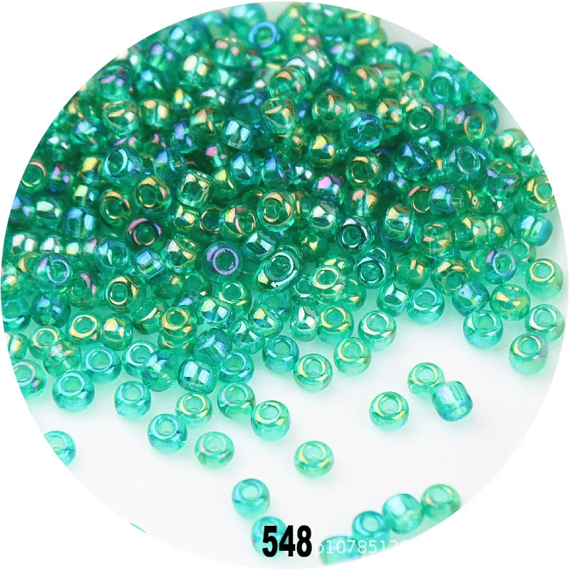A pile of colorful round loose Czech glass seed beads for jewelry making.