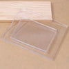 Clear silicone gel printing plates stacked on a light wooden board.