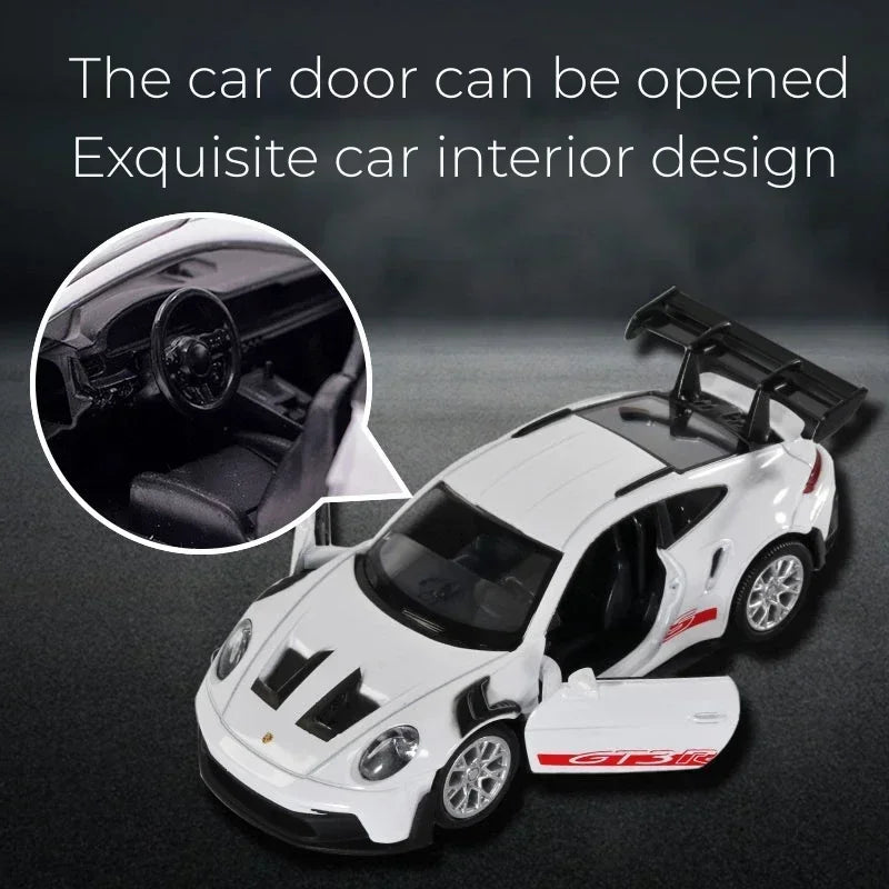 A white Porsche 911 GT3 RS diecast model car is shown with its door open, highlighting the exquisite interior design.