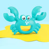 A light blue plastic toy set featuring a crab with claws and dinosaur digging tools resting on a yellow surface.