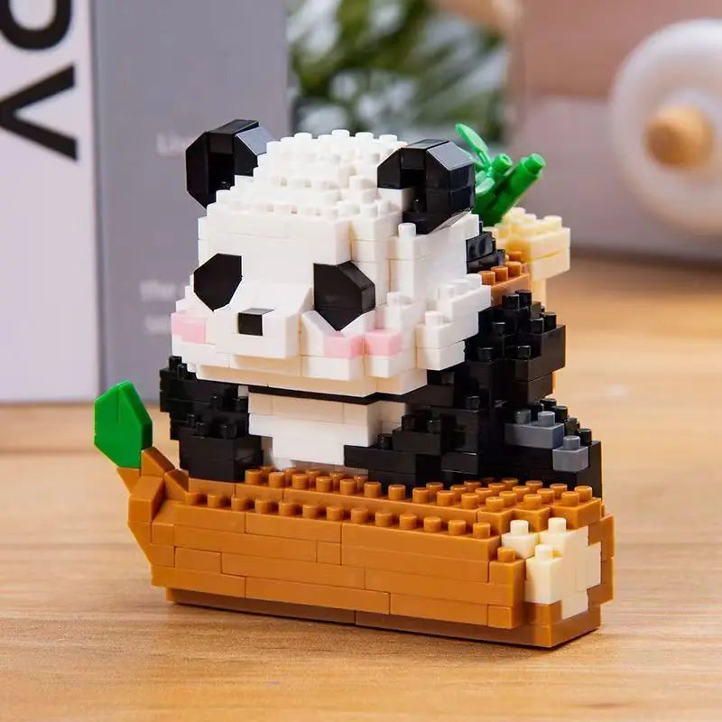A mini panda building block set featuring black and white blocks with pink accents, resting on a wooden base.