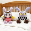 A plush doll of Maid Jax with purple ears and facial markings sitting on a white bed.