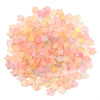A pile of colorful transparent pink and yellow star acrylic beads for jewelry making