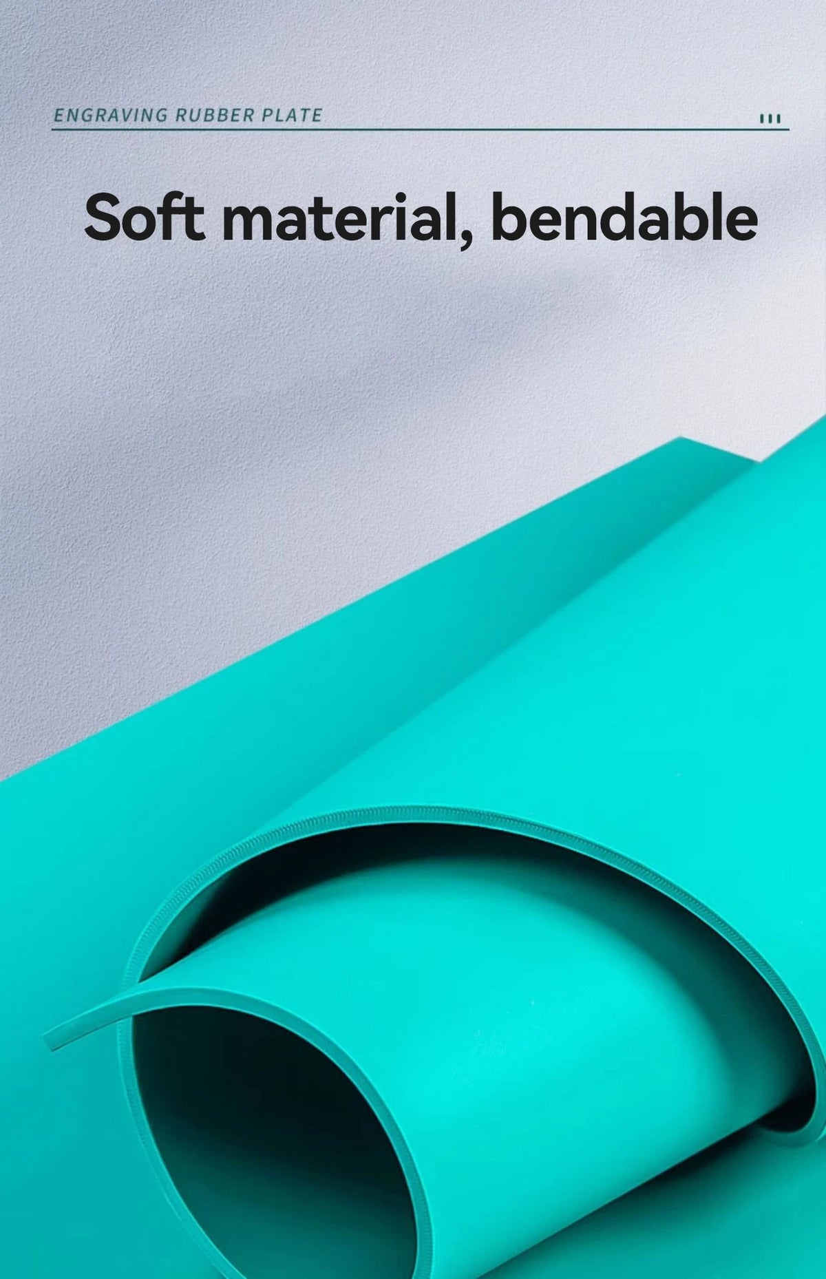 A close-up of a teal rubber plate being rolled, demonstrating its soft and bendable material.