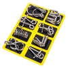A yellow plastic tray holding eight different types of metal brain teaser puzzle clips.