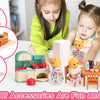 A young girl plays with a dollhouse furniture set featuring a miniature kitchen and various accessories.