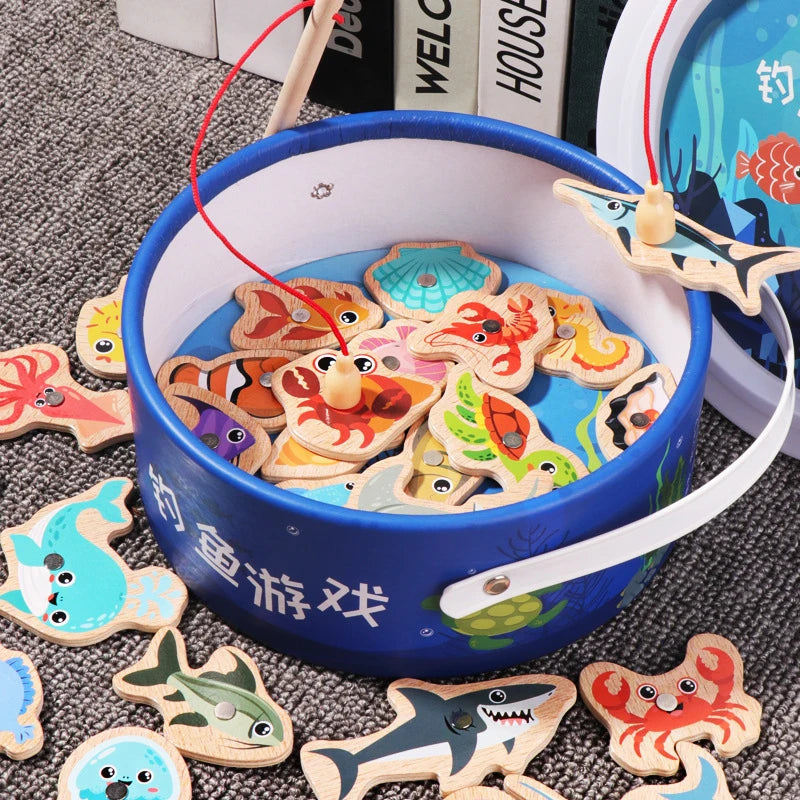 A blue wooden magnetic fishing game with various wooden fish shapes is displayed on a gray surface.