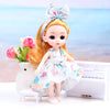 An orange-haired doll with a bow is shown wearing a light blue dress next to a white piano on a white surface.