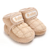 Pair of light beige baby winter cartoon boots with quilted fabric and soft lining