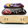 A wooden fingerboard deck with a purple and black graphic and a light wood fingerboard with six holes.