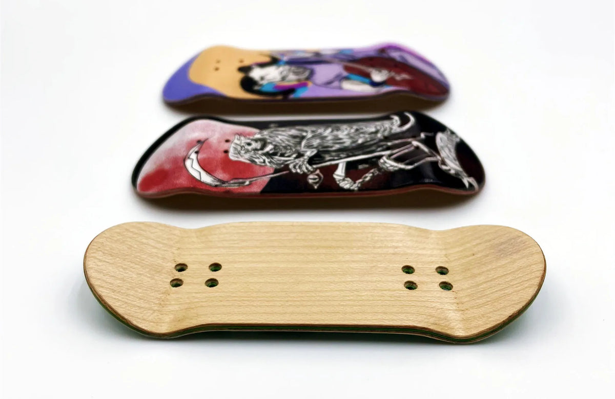 A wooden fingerboard deck with a purple and black graphic and a light wood fingerboard with six holes.