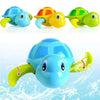 Three colorful wind-up swimming turtle bath toys in blue, orange, and green.