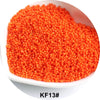 A pile of bright orange 1.5mm solid glass seed beads for jewelry and craft.