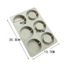 A silicone mold tray with six circular depressions for making soap or candles.