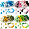 A collection of colorful silicone beads in various shades including blue, pink, white, and green arranged on a white platter.