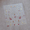 Sheet of gold and red glitter nail art stickers featuring stars moons and hearts for gothic designs
