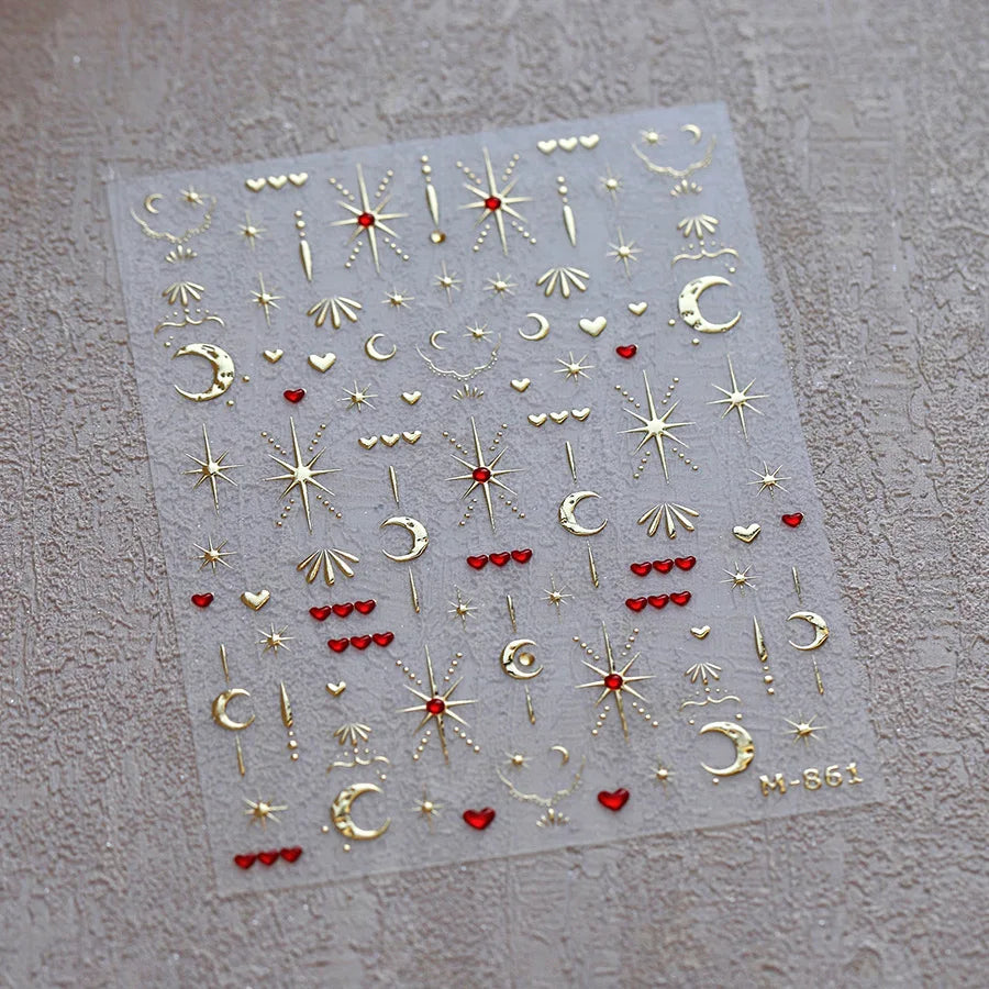 Sheet of gold and red glitter nail art stickers featuring stars moons and hearts for gothic designs