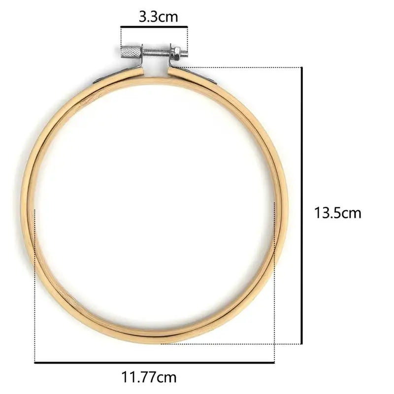 A gold-colored adjustable hoop for needlecraft, measuring 13.5cm in diameter and 3.3cm in height.