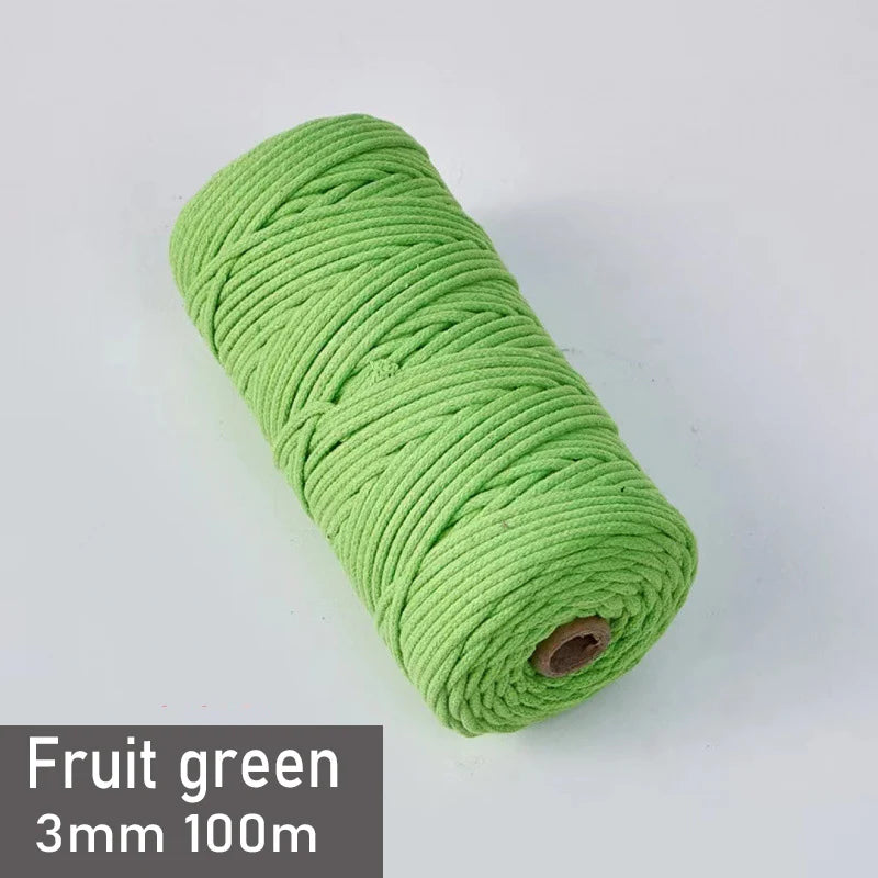 A spool of bright green 3mm cotton macrame cord measuring 100 meters for DIY crafts.