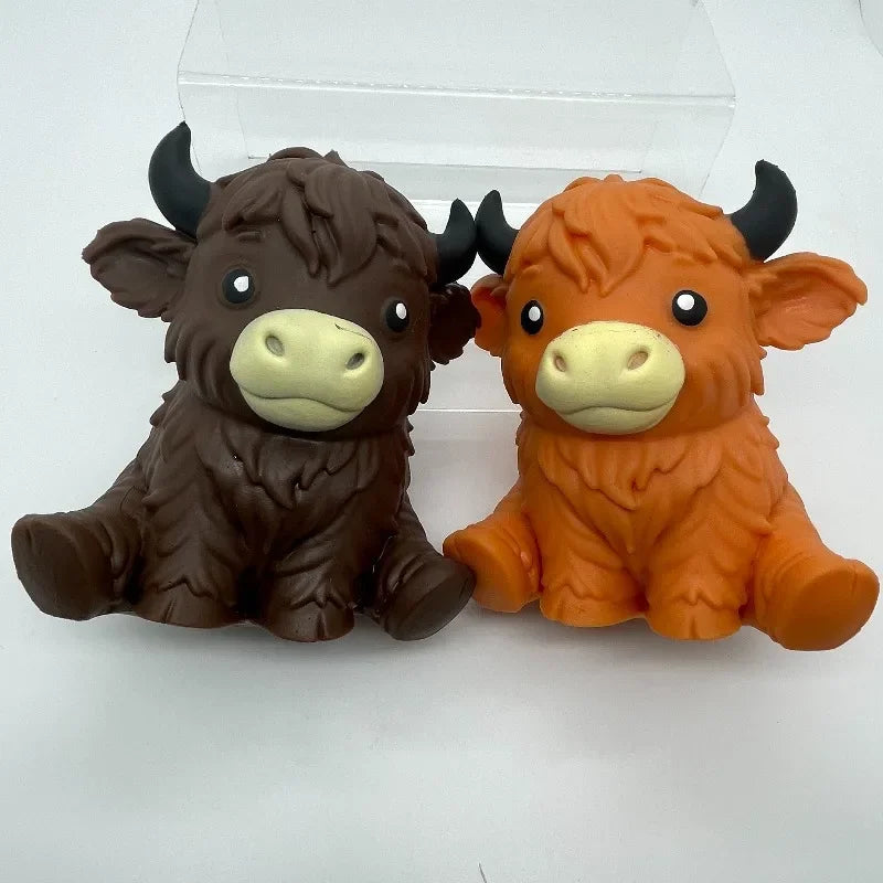 A pair of brown and orange jumbo highland cow squishy stress balls or fidget toys.