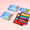 A set of colorful washable non-toxic crayons in individual boxes with triangular grips displayed on a pink background.