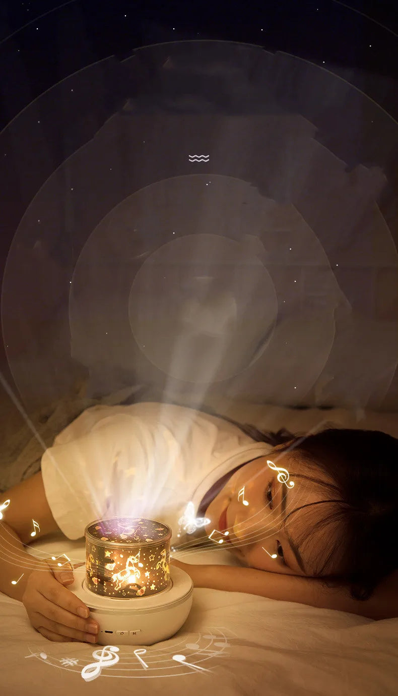 A young girl is looking at a glowing projector night light with rotating galaxy effects on her face.