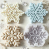 A collection of white and light blue snowflake silicone molds for crafting candles, soap, and wax melts.