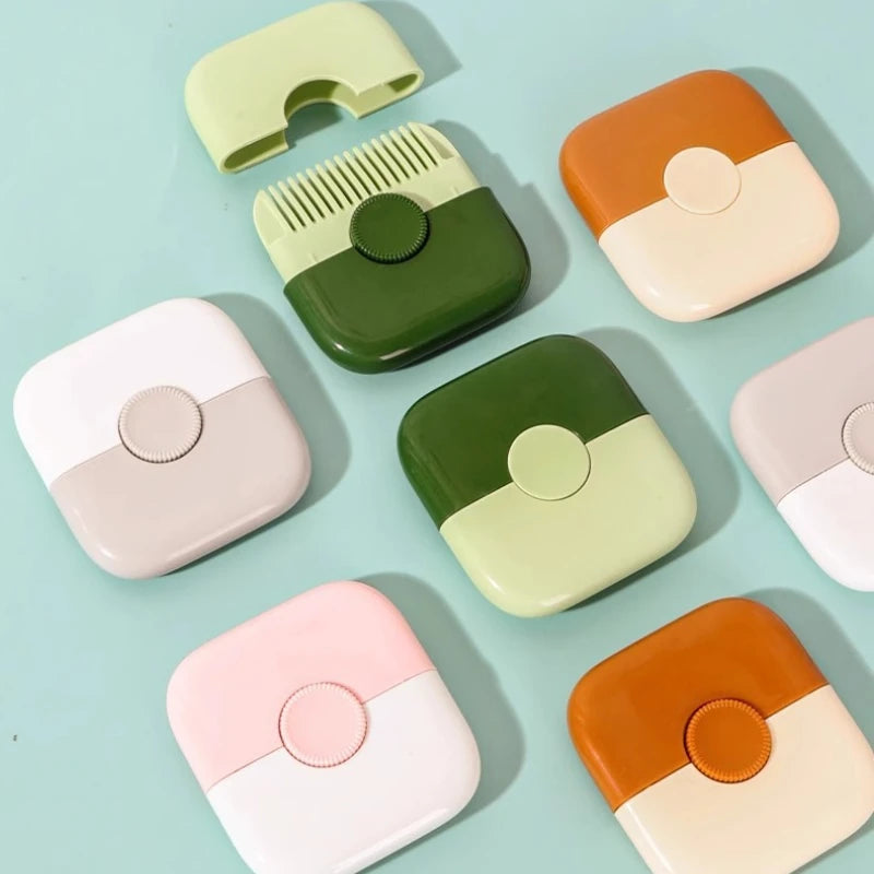 A collection of light green and orange baby hair cutting combs arranged on a pale blue background.