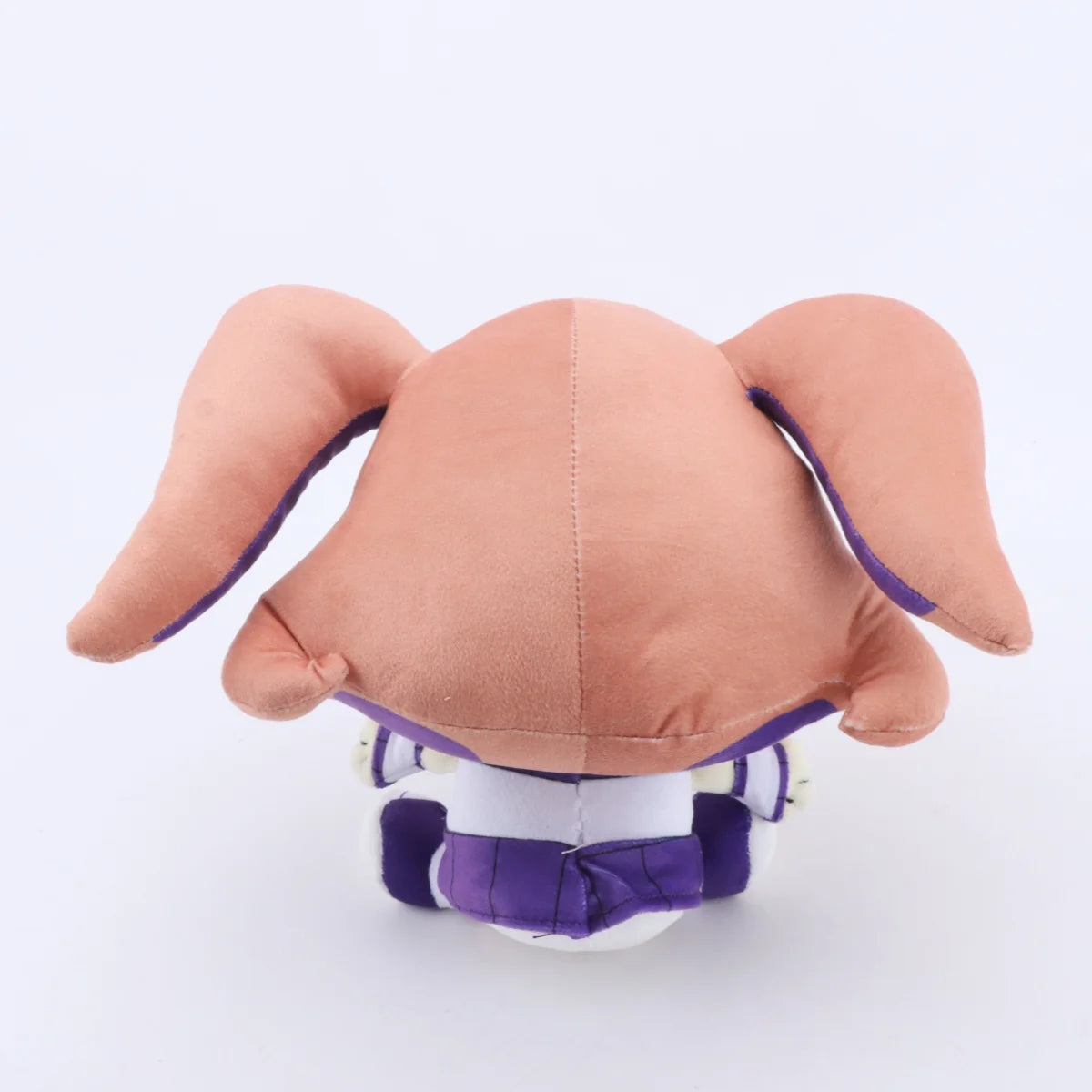 A soft collectible doll plush toy with a light brown head and purple accents.