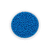 A clear container filled with bright blue round glass seed beads for jewelry making