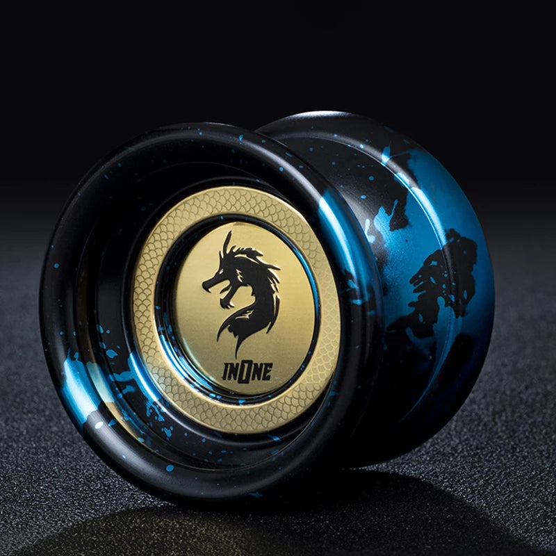 A close-up of a black and blue yo-yo with a gold logo featuring a silhouette of a dragon.