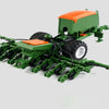 A green remote control tractor with a trailer and lights is shown on a light gray background.
