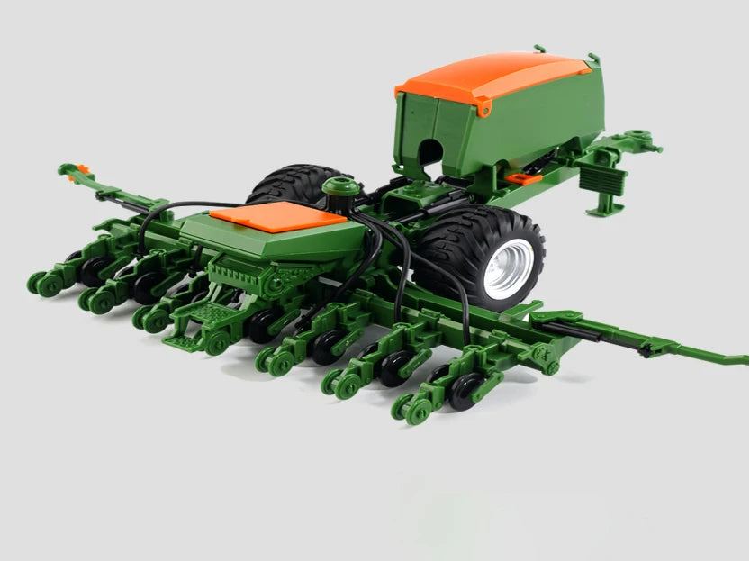 A green remote control tractor with a trailer and lights is shown on a light gray background.