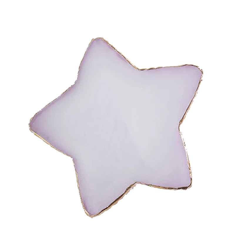 A translucent lavender star-shaped resin nail art palette with a gold trim.