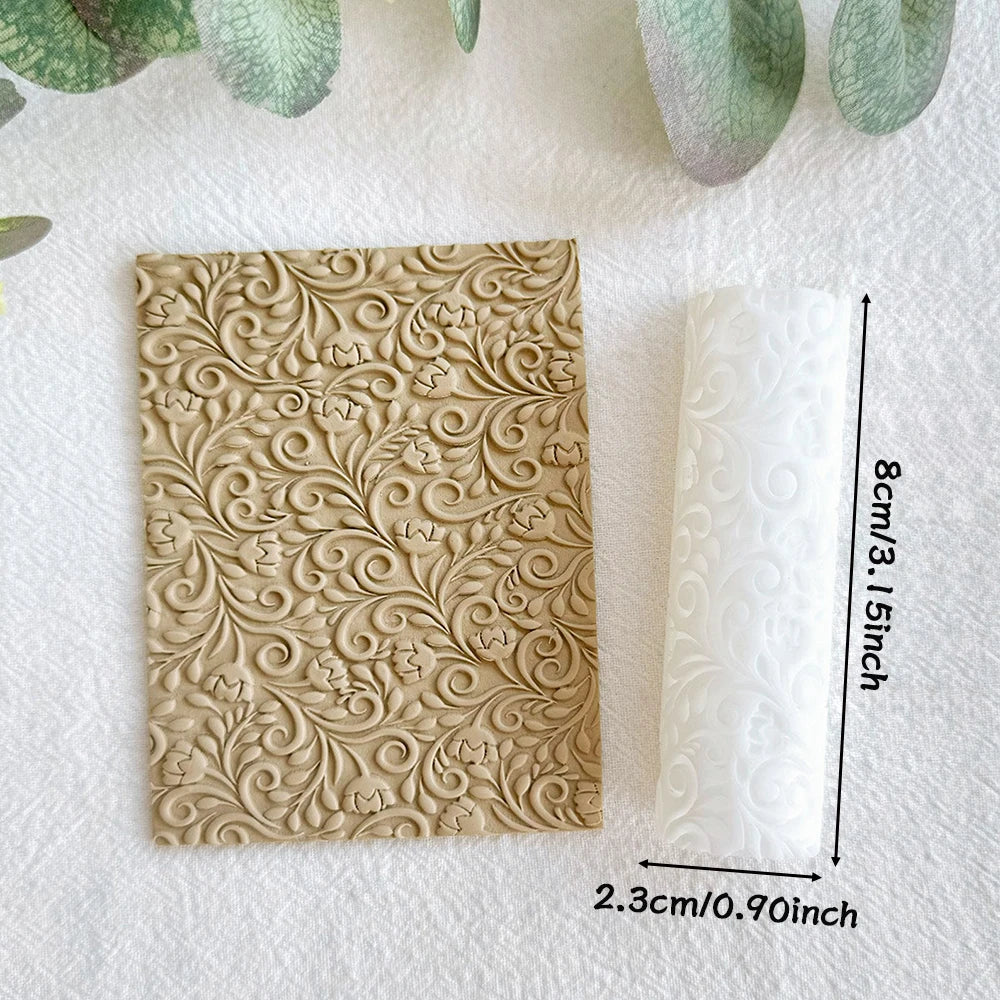 A beige clay texture roller is shown next to a white rolled item on a light surface.