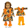 A doll outfit set featuring a black blouse, sunflower print skirt, and orange tights.