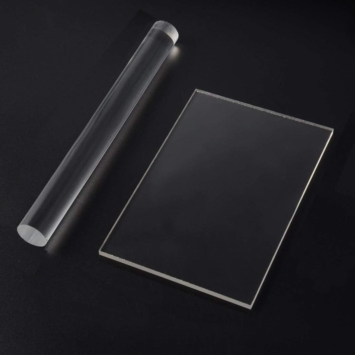 A clear acrylic clay roller and sheet set displayed on a dark surface.