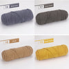 Three skeins of soft cotton blend yarn in shades of gray, camel, khaki, and ginger yellow for knitting and crochet.