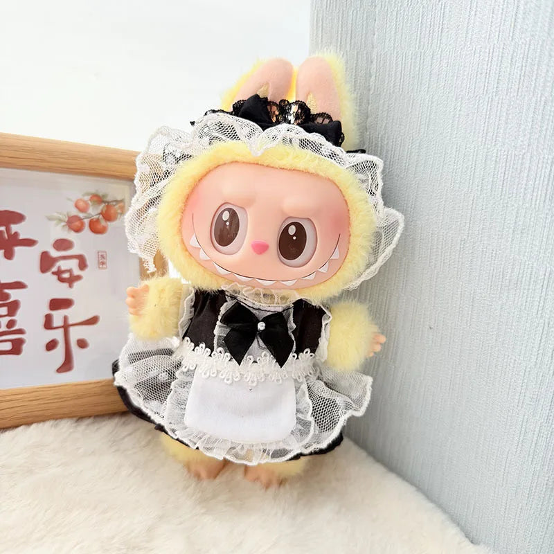 A fluffy yellow rabbit doll dressed in a black and white frilly dress with a lace veil and princess shoes.