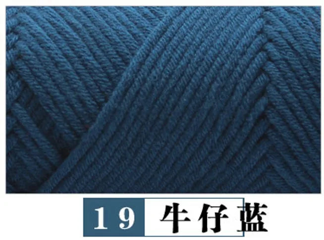 A close-up texture of dark blue premium milk cotton yarn used for knitting.