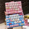 A set of pink and blue cartoon animal keycap keychains arranged in a rectangular tray.