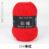 A ball of bright red milk cotton yarn labeled 20# silk red for knitting and crochet.