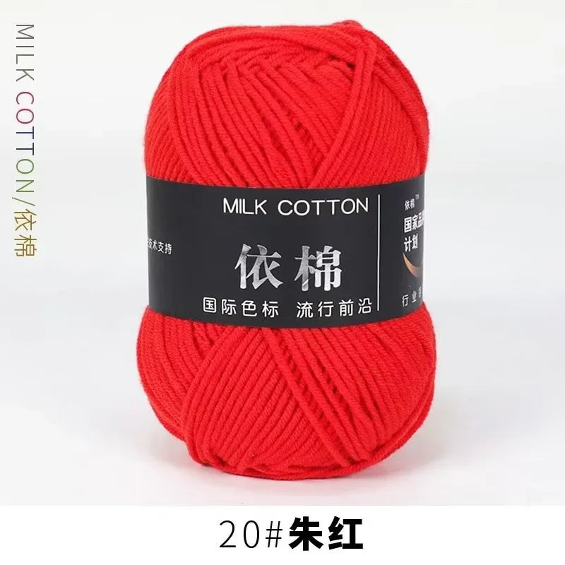 A ball of bright red milk cotton yarn labeled 20# silk red for knitting and crochet.